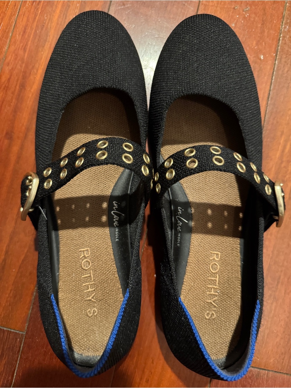 Rothy's Black Knit Flats with Gold Eyelet Strap and Blue Heel Trim. Runs small